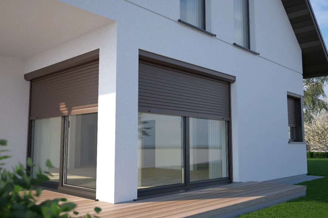 Modern white house with brown external roller shutters fitted above large windows and patio doors.